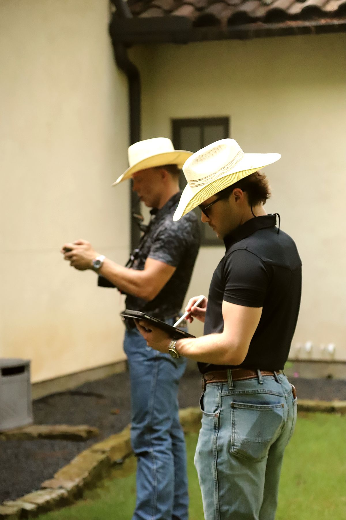 Two crew members review notes and framing on location between takes